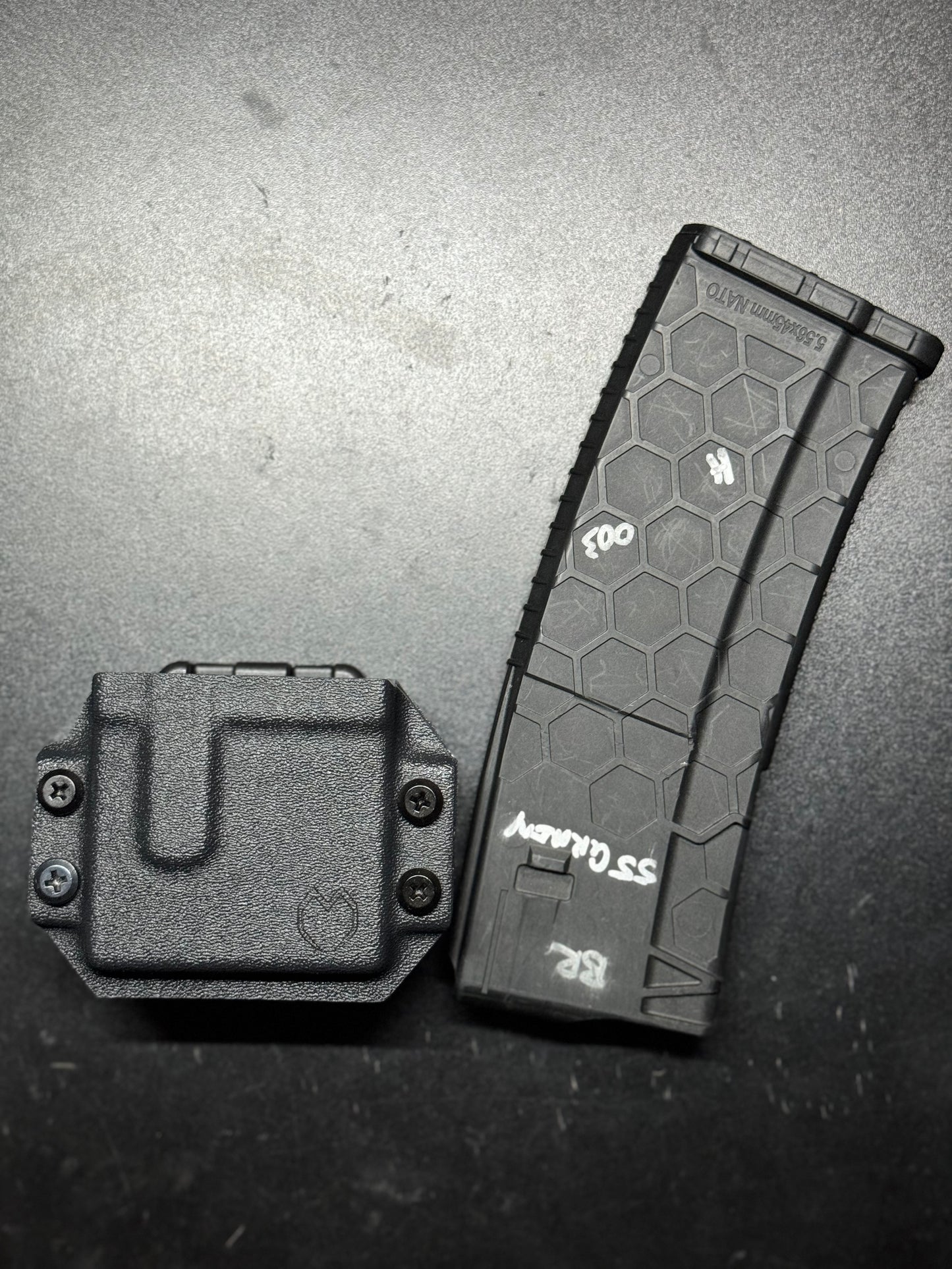 Custom-made Kydex magazine carrier in matte black, featuring a sleek, low-profile design with adjustable retention for quick and secure magazine access. Dual magazine carrier crafted from durable Kydex in a tactical coyote brown, designed for both concealed and open carry with a sturdy belt clip. Versatile and handcrafted Kydex magazine carrier in a discreet gray, equipped with an adjustable cant for comfortable carry in various positions.