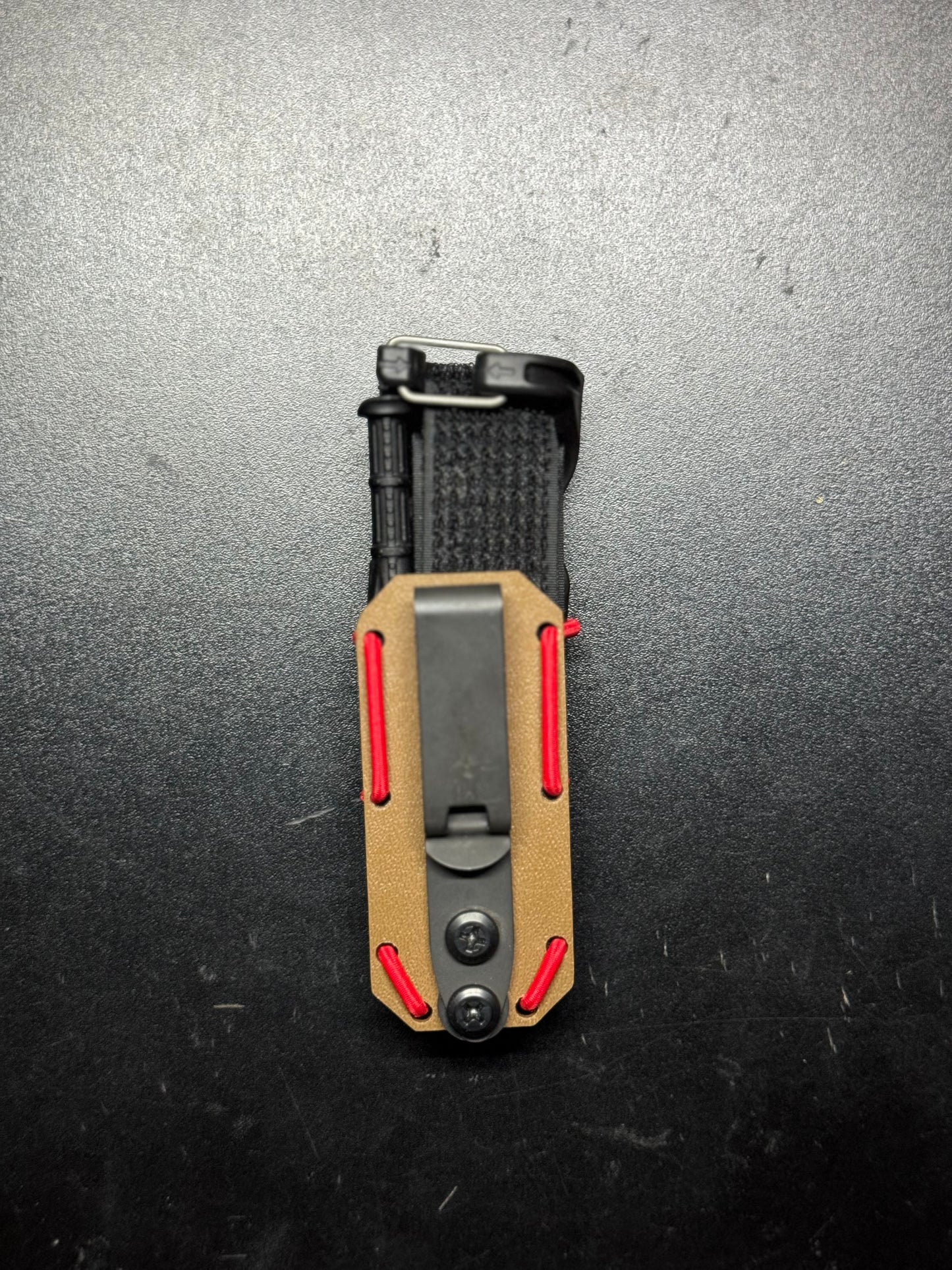 Robust handmade Kydex Tourniquet Carrier for CAT Gen7, in tactical black, designed for quick access and secure retention of the tourniquet in emergency situations. Durable and lightweight Kydex TQ Carrier for CAT Gen7, with a sleek carbon fiber pattern, providing both style and functionality for first responders.