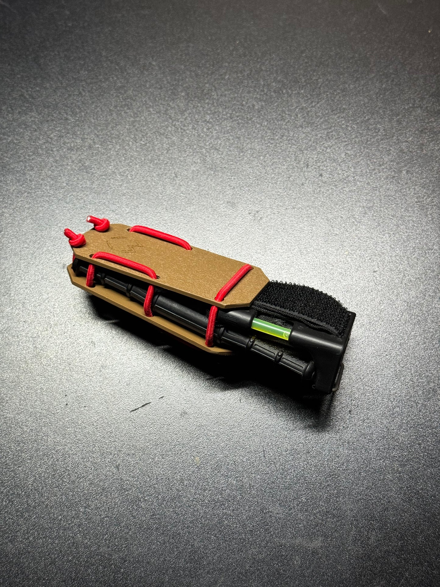 Robust handmade Kydex Tourniquet Carrier for CAT Gen7, in tactical black, designed for quick access and secure retention of the tourniquet in emergency situations. Durable and lightweight Kydex TQ Carrier for CAT Gen7, with a sleek carbon fiber pattern, providing both style and functionality for first responders.