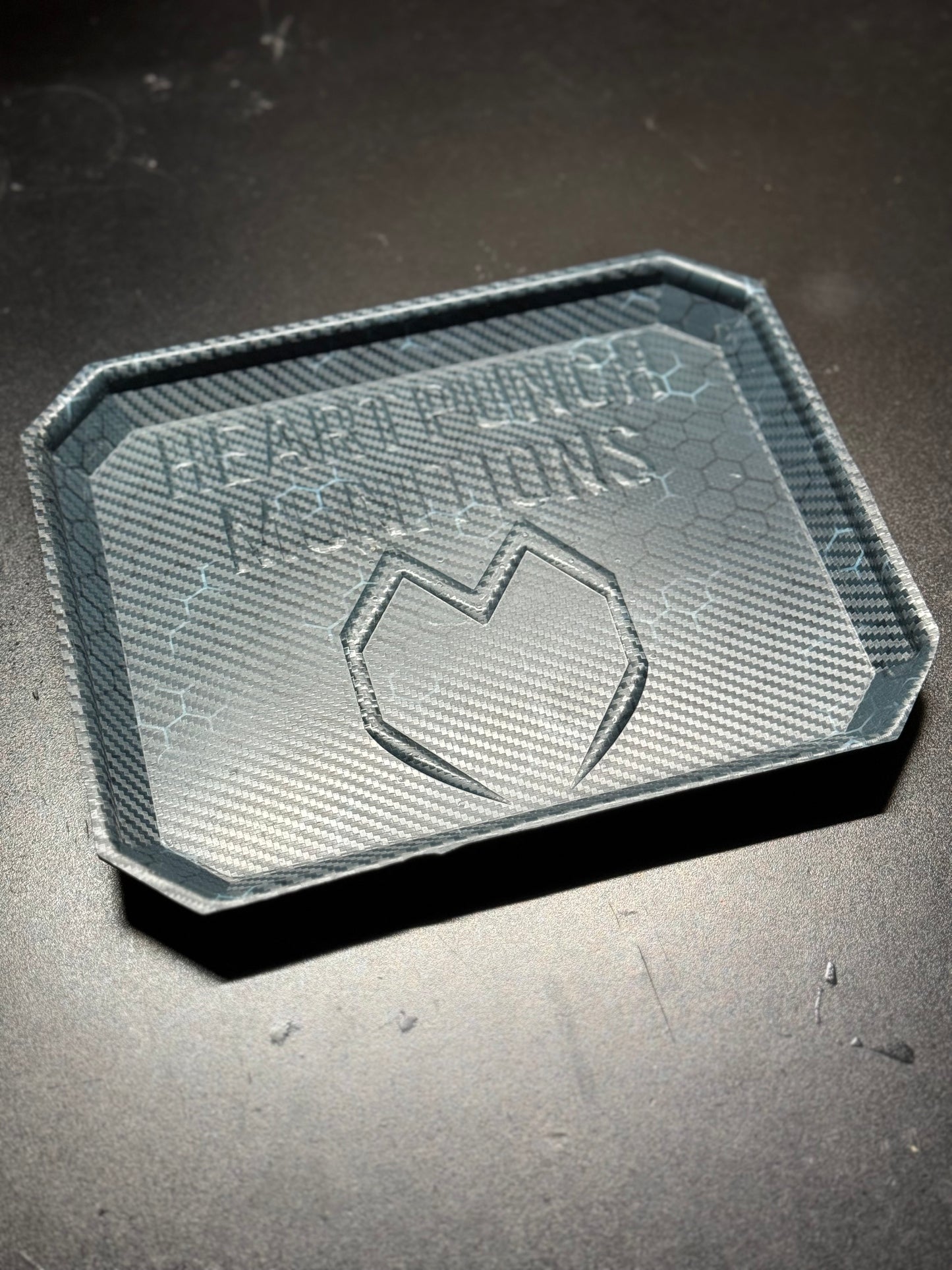 Durable Kydex dump tray in matte black, handcrafted with raised edges, perfect for organizing everyday carry items like keys, coins, and wallets.