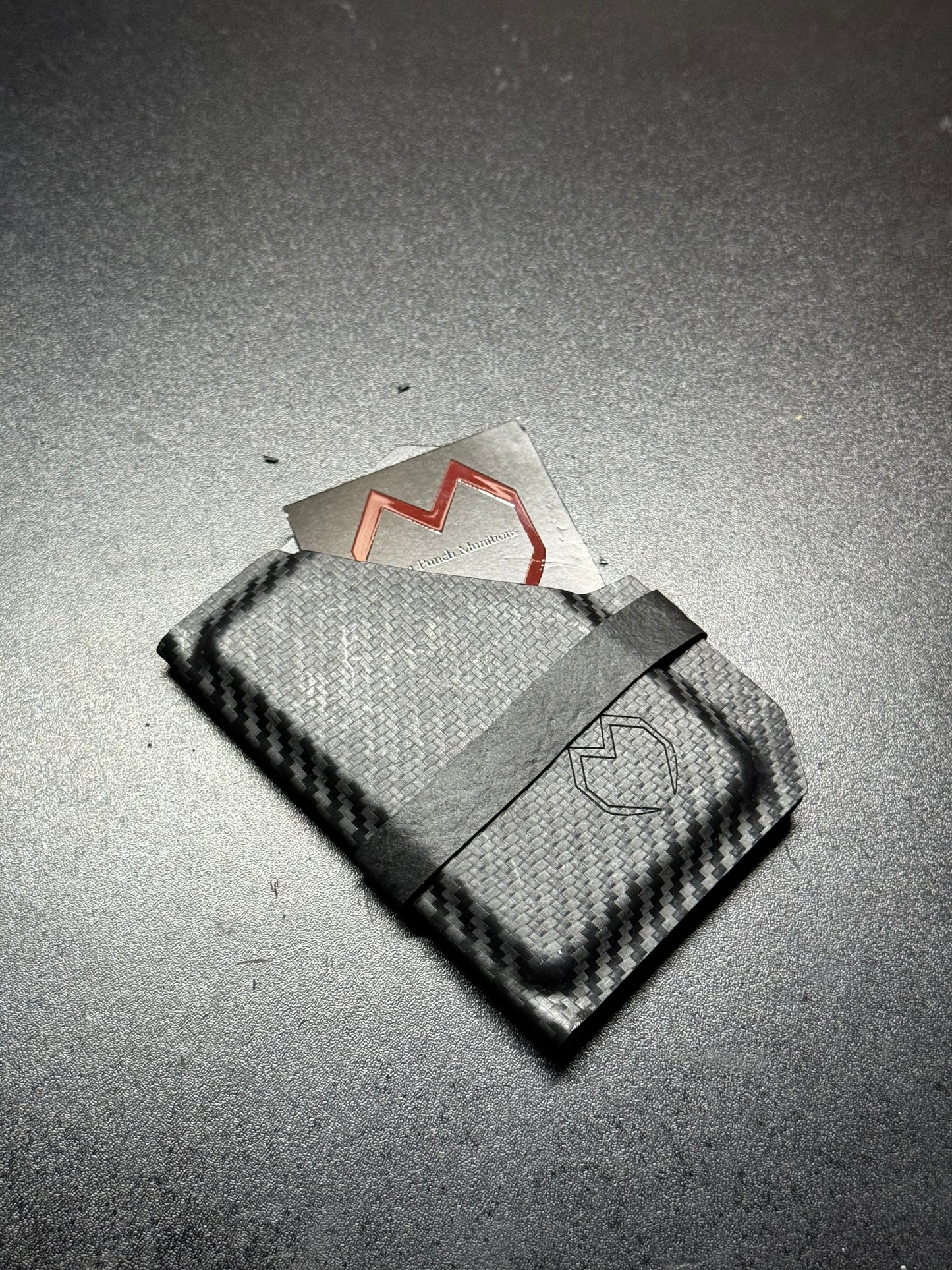 Slim and sleek handmade Kydex wallet in matte black, featuring a minimalist design with a durable and rigid structure for secure card holding.