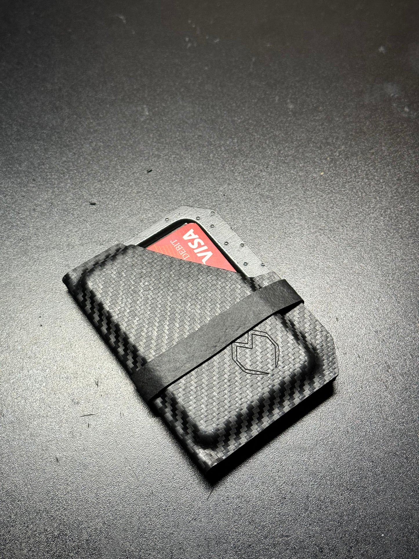 Slim and sleek handmade Kydex wallet in matte black, featuring a minimalist design with a durable and rigid structure for secure card holding.