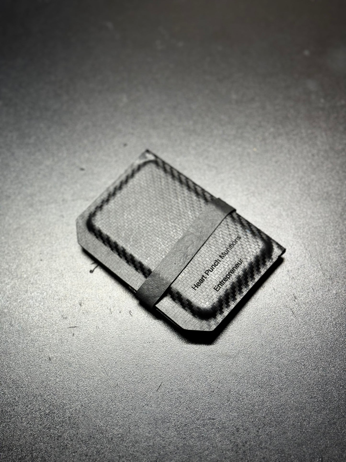 Slim and sleek handmade Kydex wallet in matte black, featuring a minimalist design with a durable and rigid structure for secure card holding.